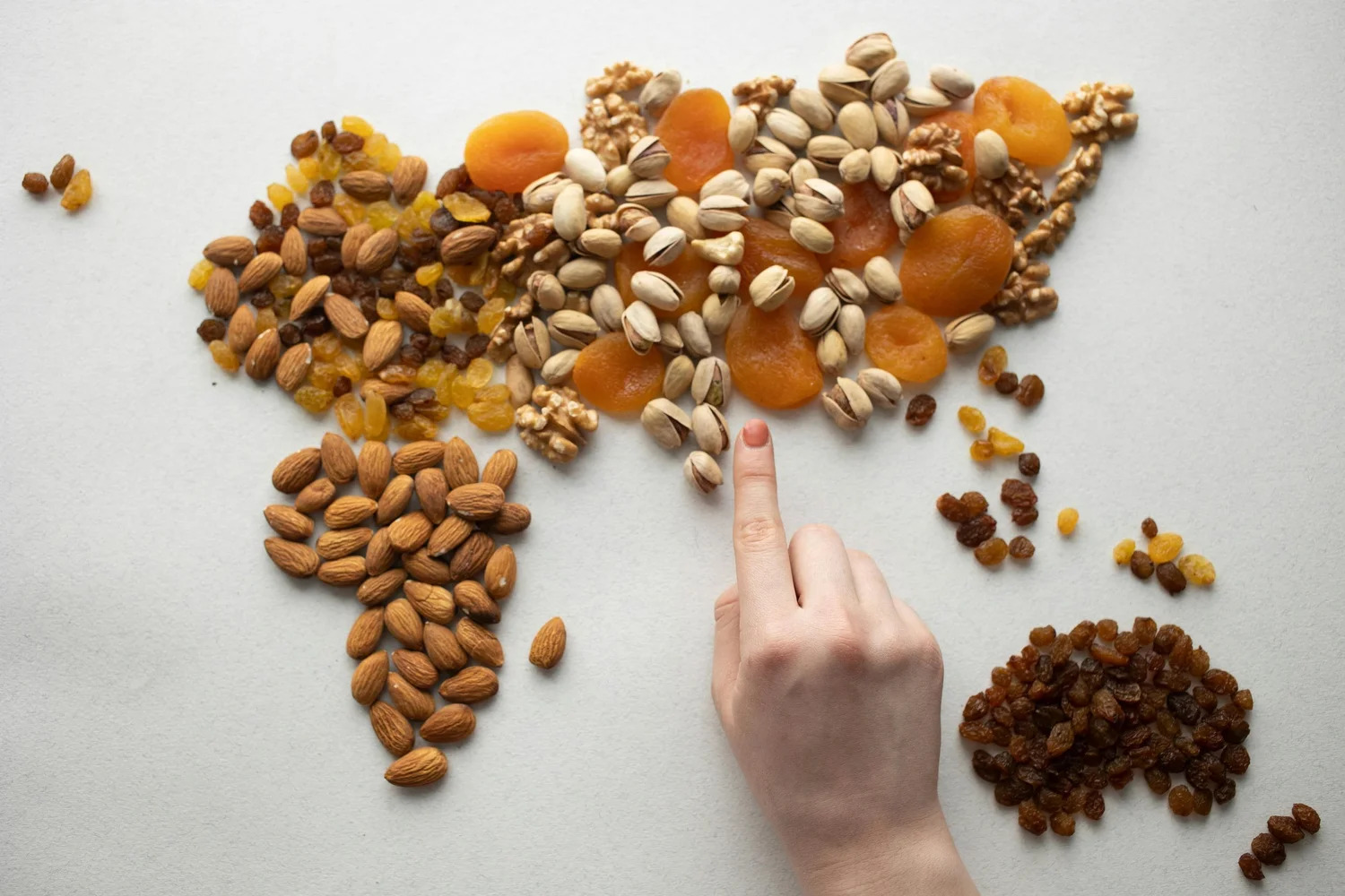 Nuts and dried fruit arranged in the shape of a world map