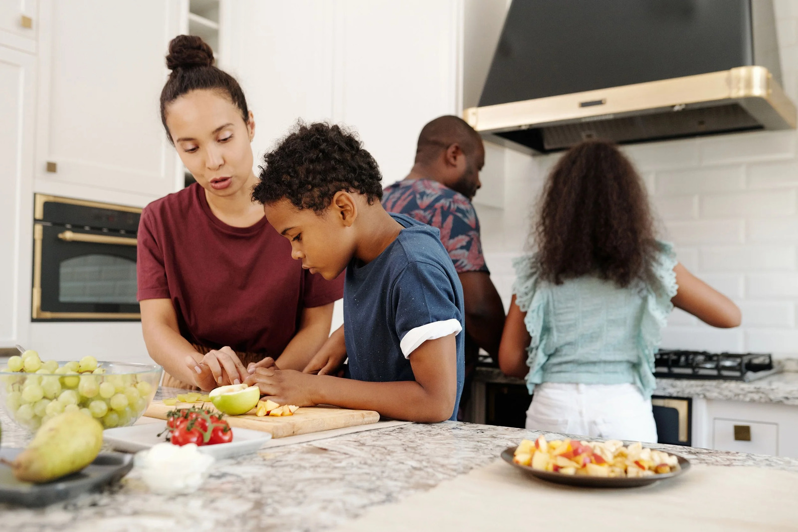 A family preparing a meal together at a kitchen counter