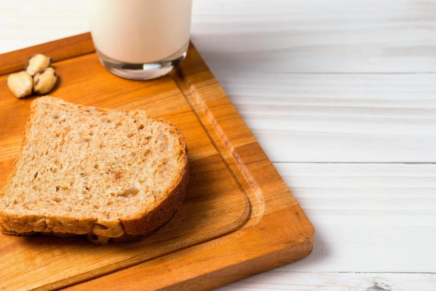 A single slice of bread on a wooden board