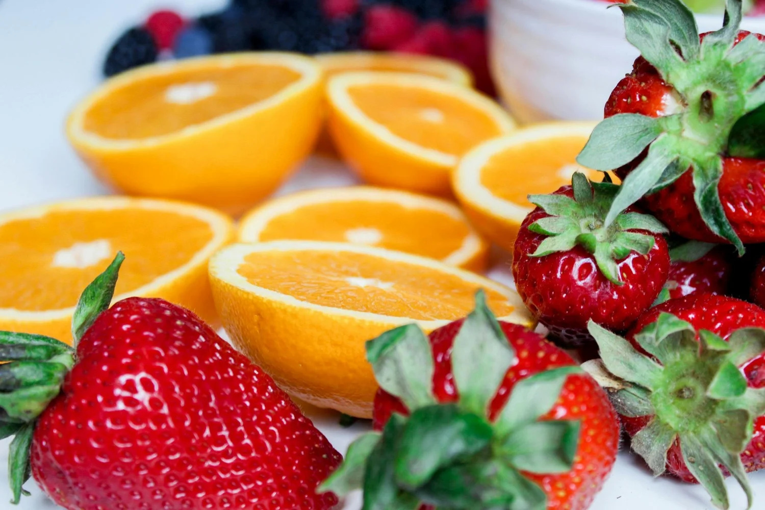 Halved oranges and fresh strawberries
