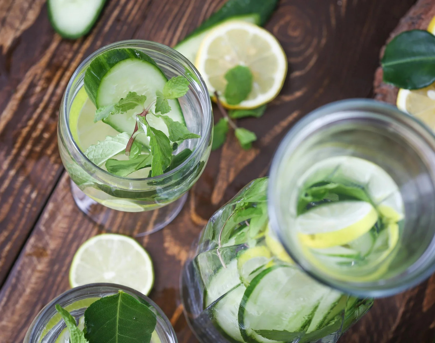 Glasses of water infused with cucumber, lemon and mint