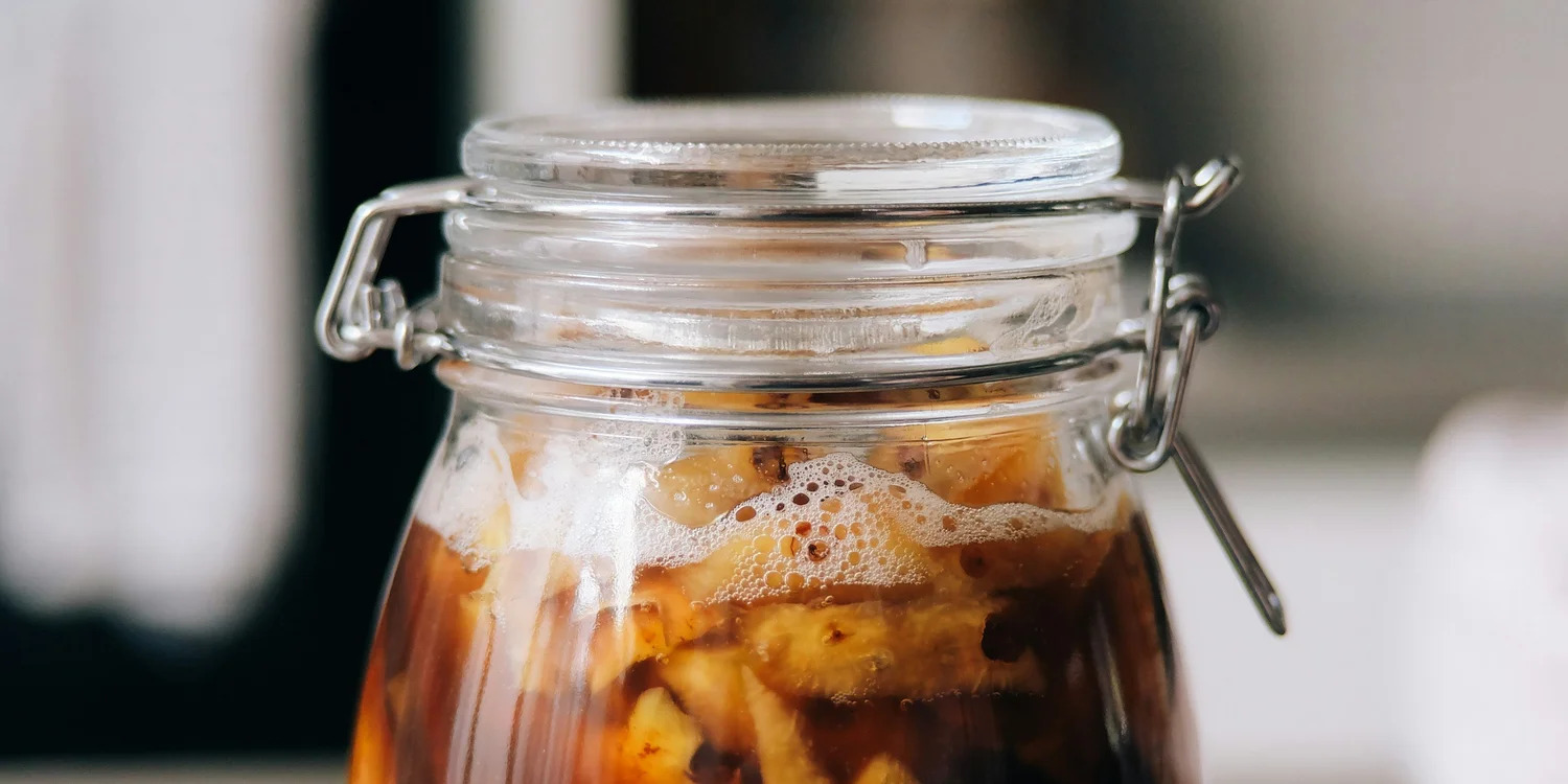 A sealed glass jar of fermenting food