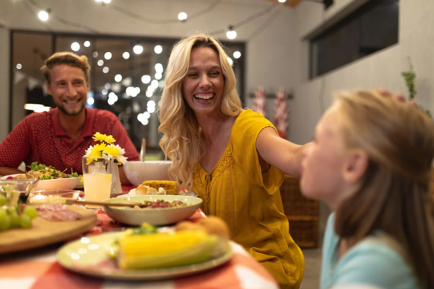 A family laughing together around a dinner table
