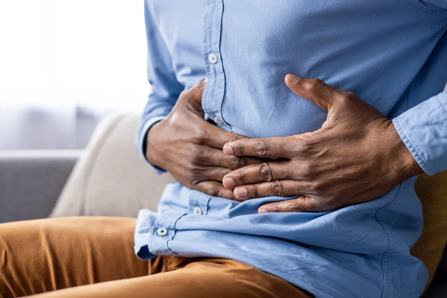 A man holding his stomach with both hands
