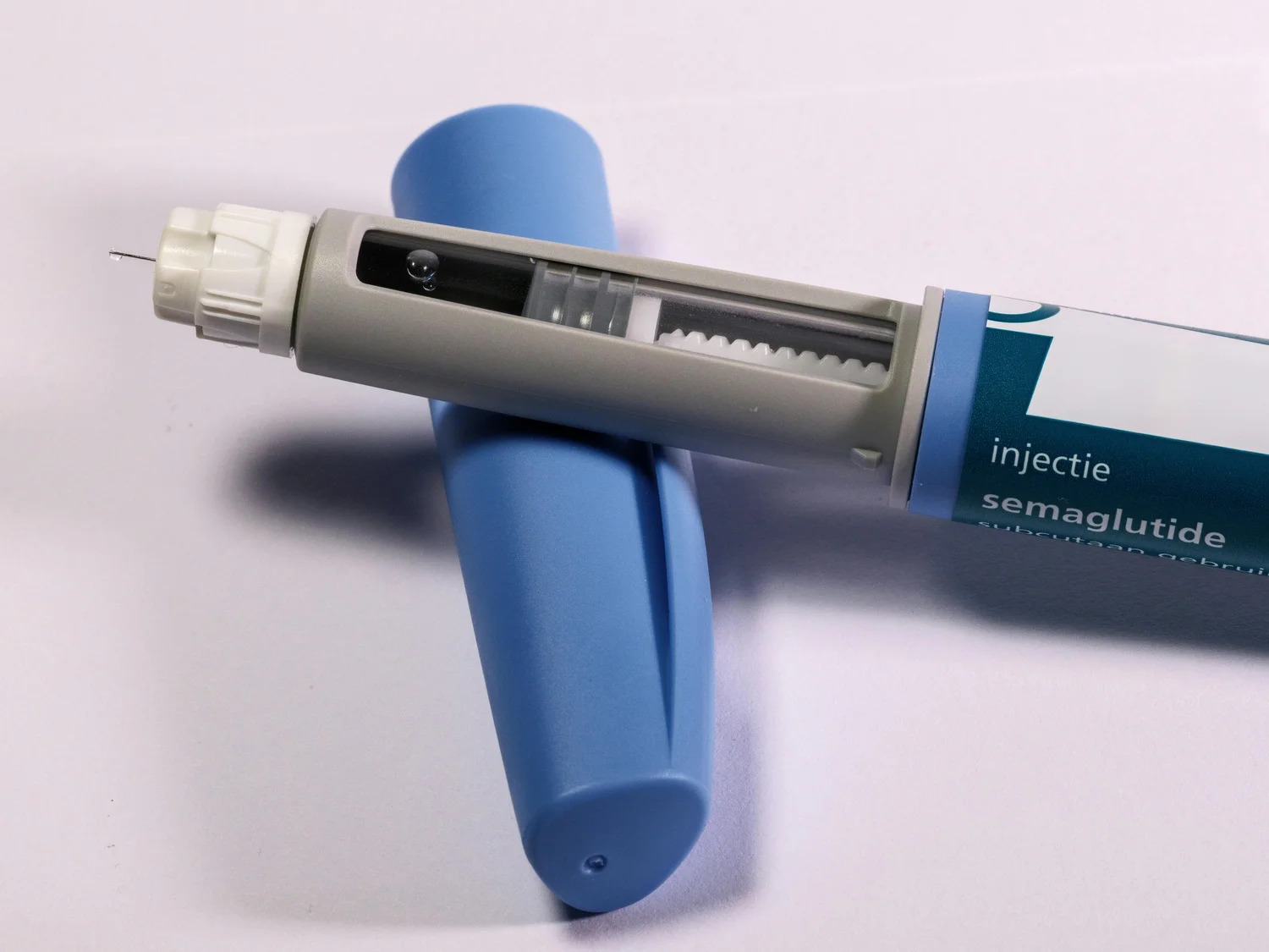 A GLP-1 medication injection pen on a white surface