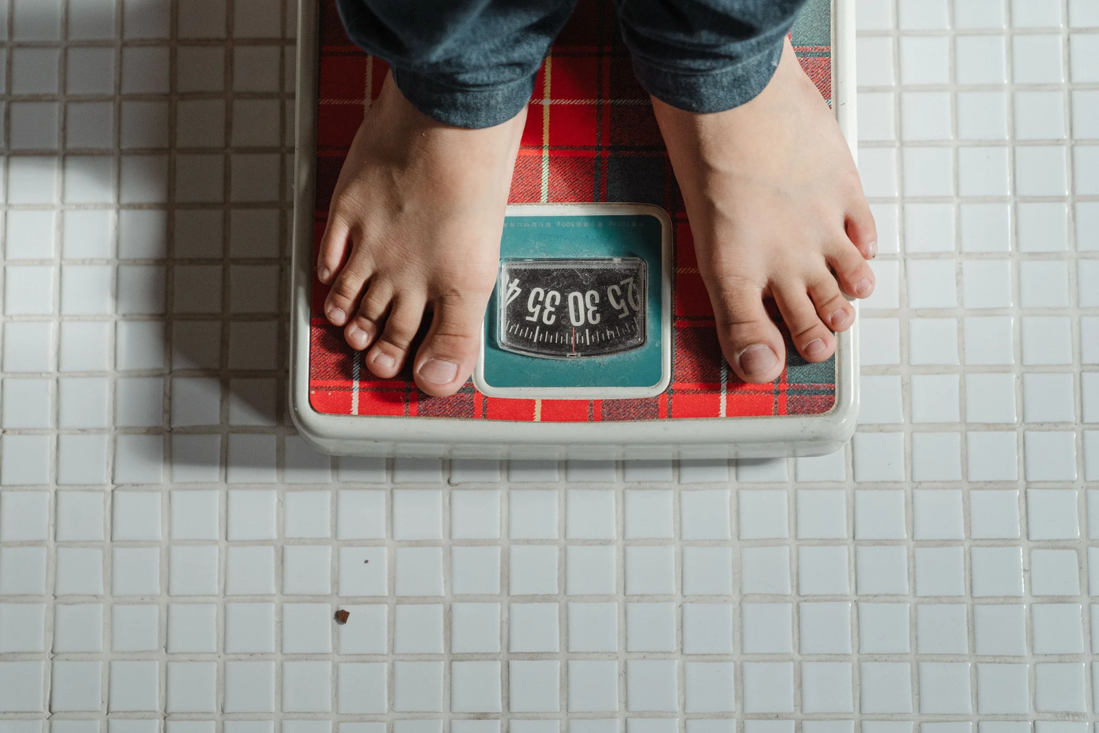 Bare feet standing on a bathroom scale