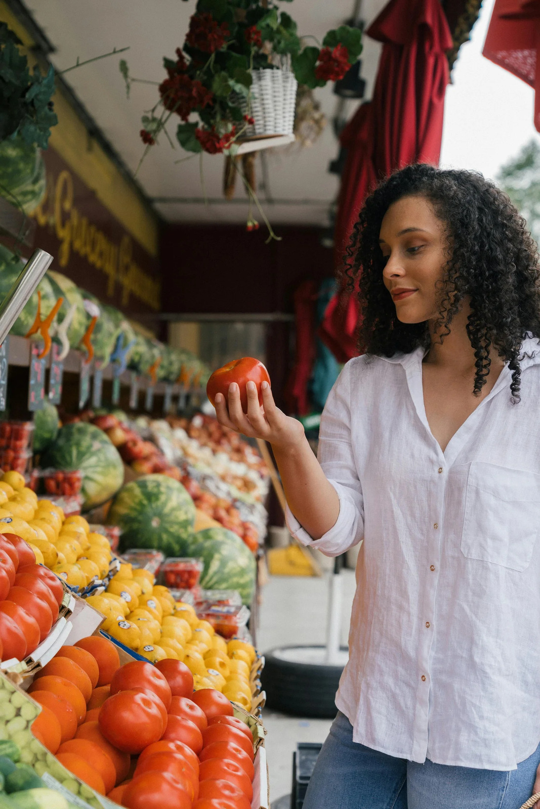 A woman choosing fresh produce at a market stall