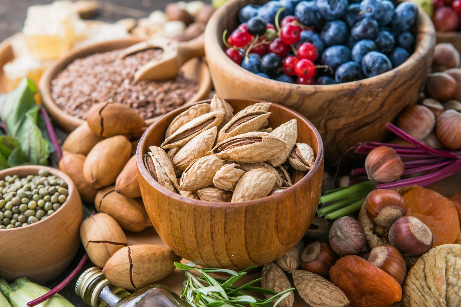 Bowls of almonds, hazelnuts, lentils and blueberries
