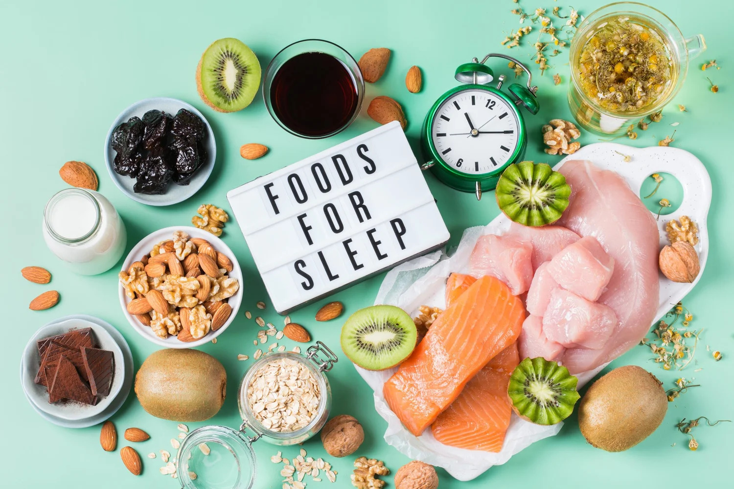 A flat lay of foods for sleep, including kiwi, salmon, nuts and cherries