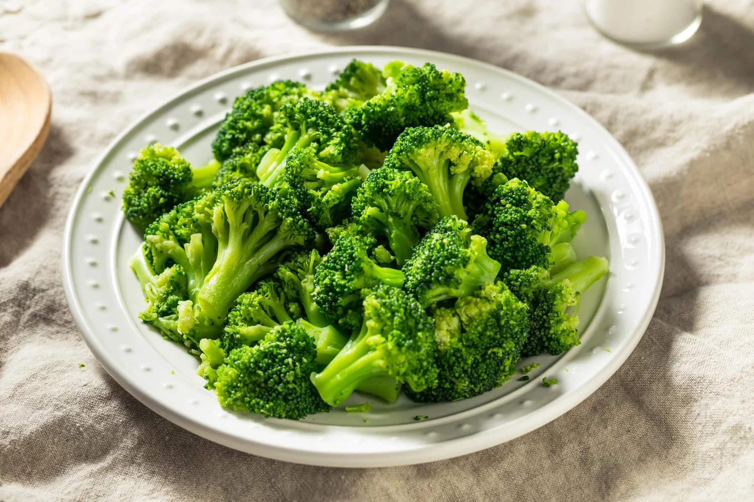 A plate of steamed broccoli florets