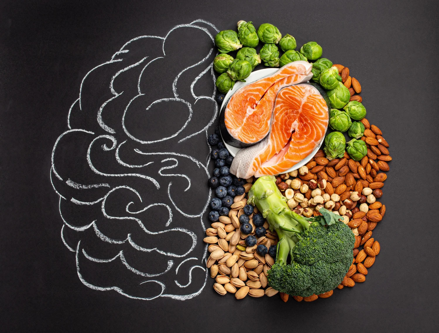 A chalk drawing of a brain beside salmon, nuts, broccoli and berries