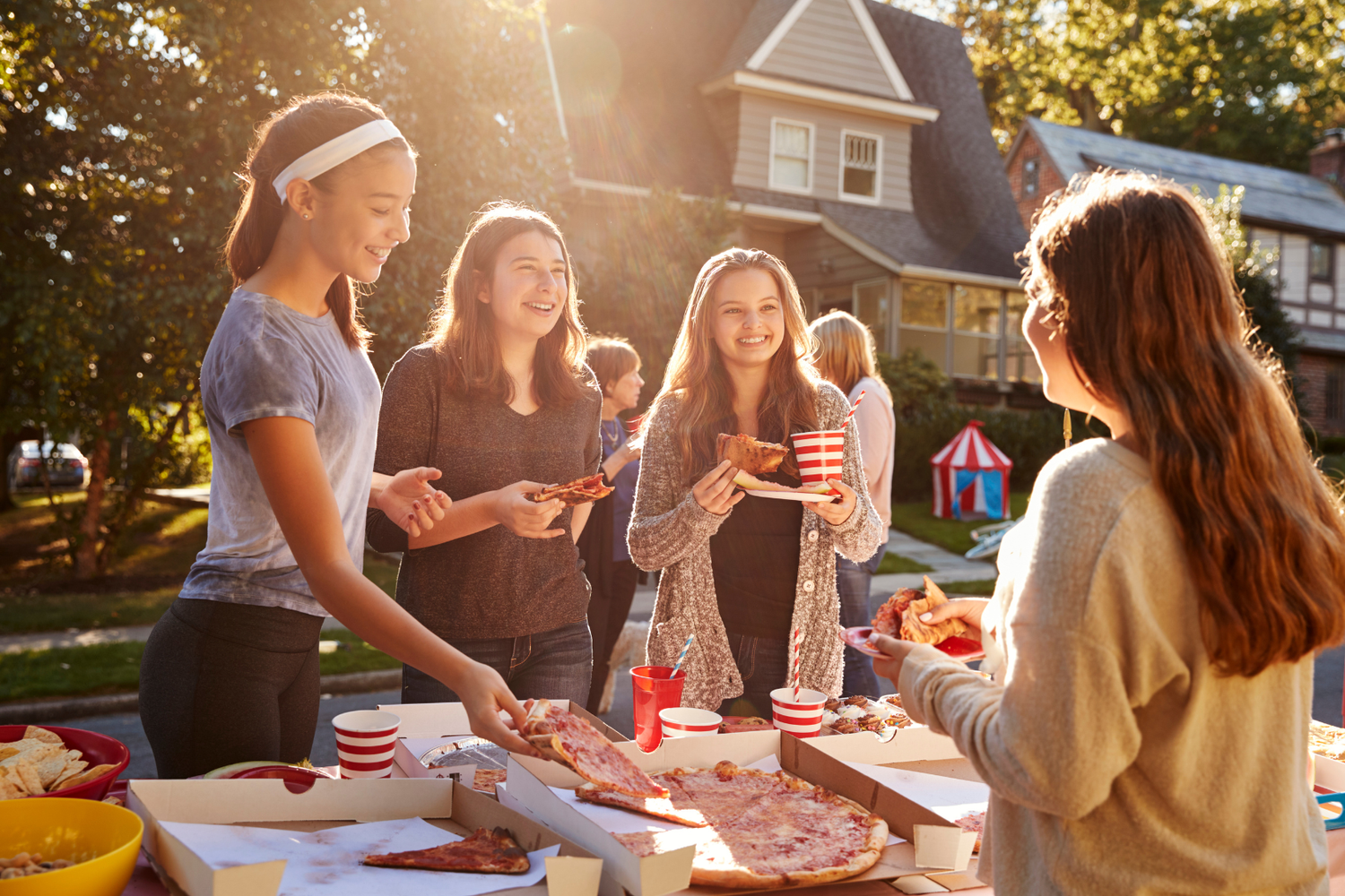 Teenagers eating together at a shared table